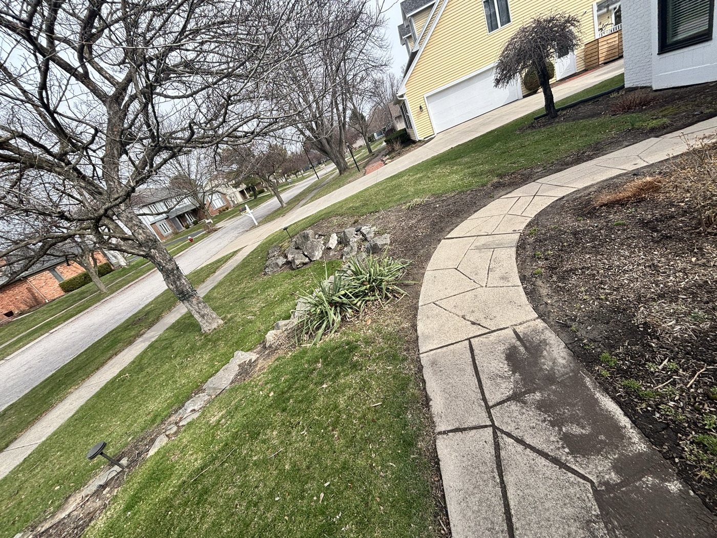 Residential landscape bed before mulch refresh